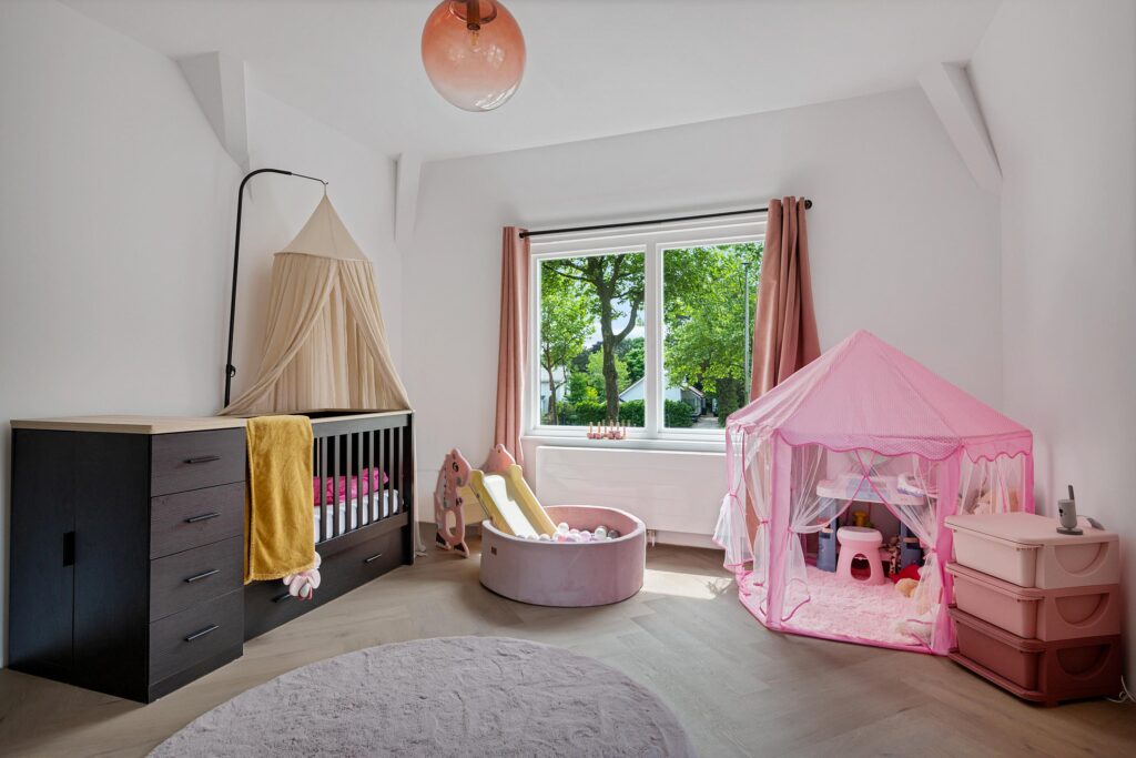 Cozy nursery with crib and play tent.