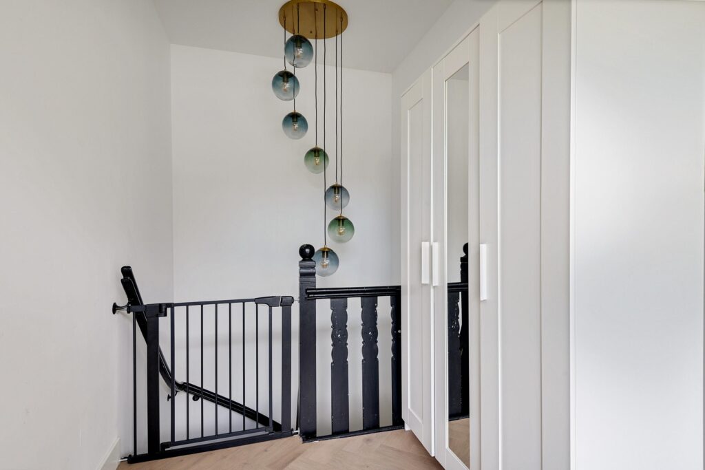 Modern staircase with hanging glass light fixtures.
