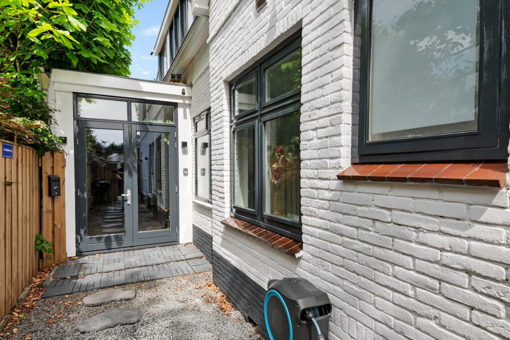 Modern white brick home with glass door entrance
