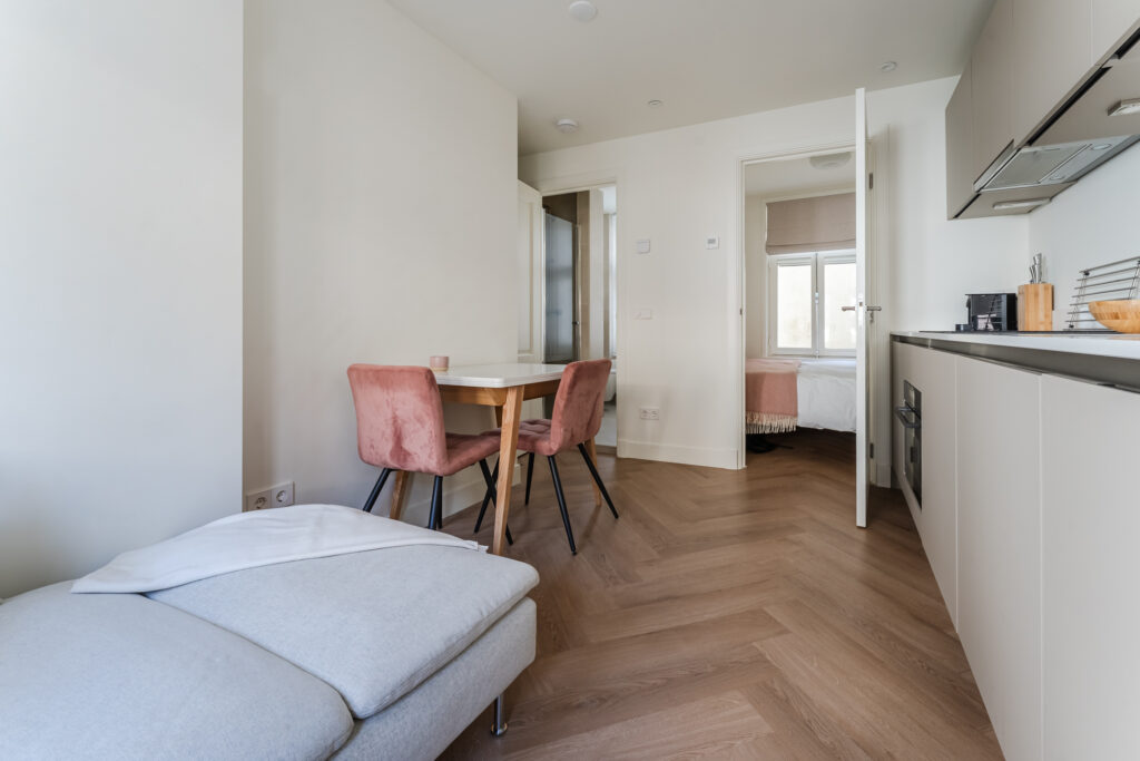Modern kitchen with wooden floor and dining area