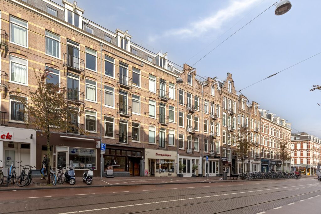 Brick buildings along urban street with bikes parked.