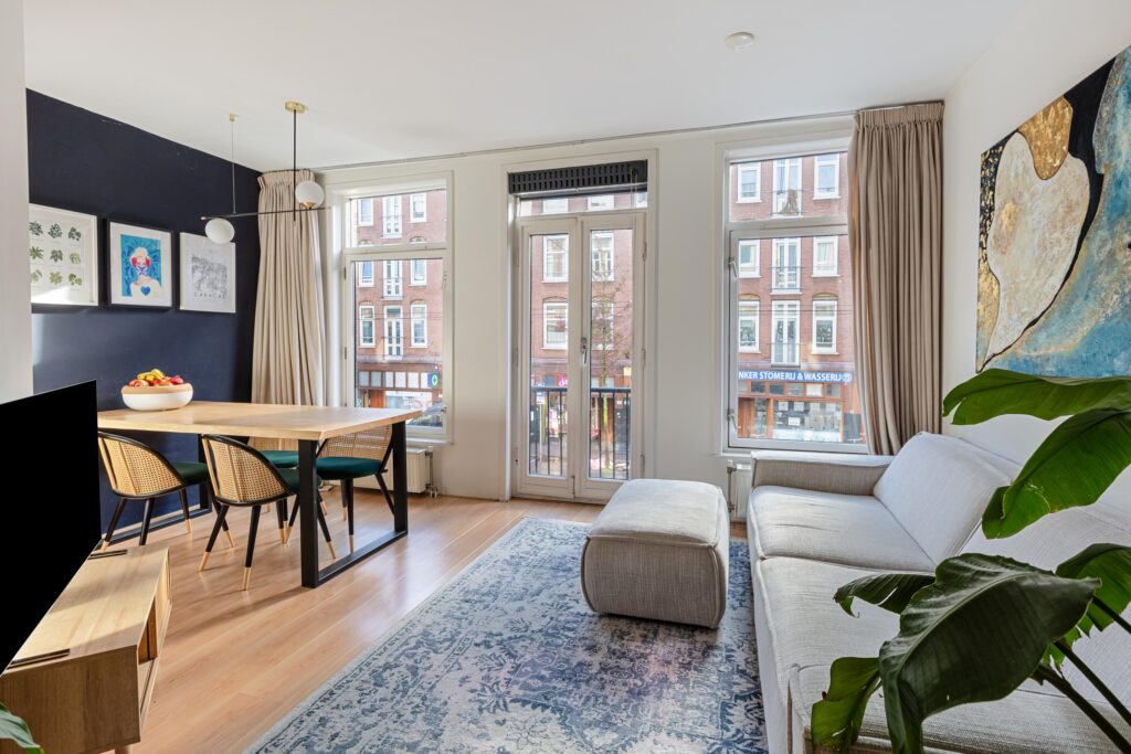 Bright living room with modern decor and large windows.