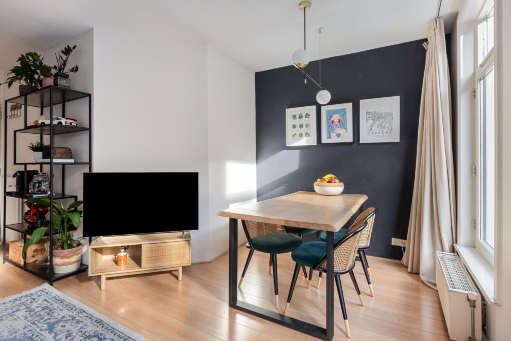 Modern dining area with wood table and decor.