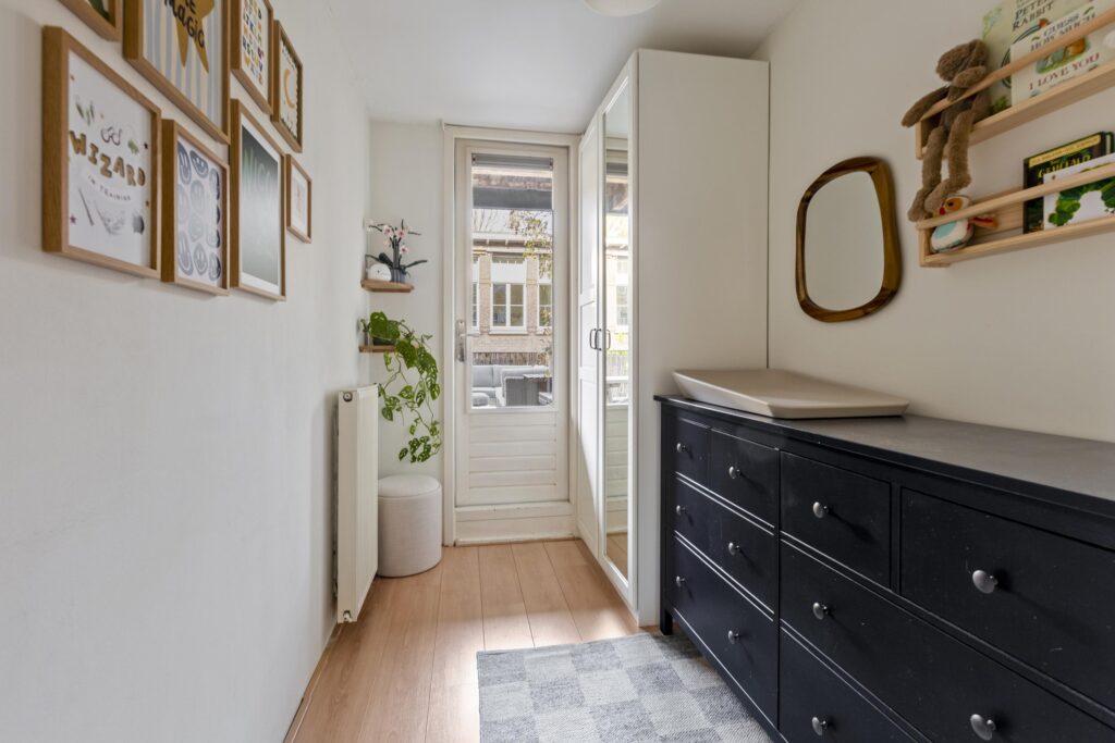 Minimalist room with dresser and wall art decor.