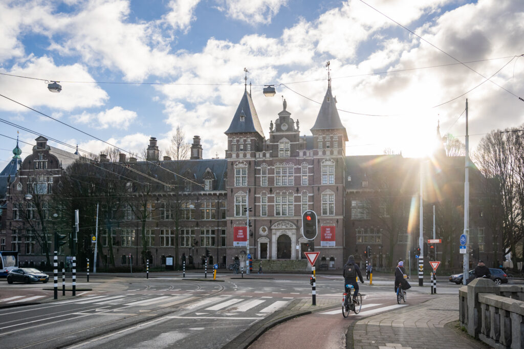 Historic building with cyclists on sunny day