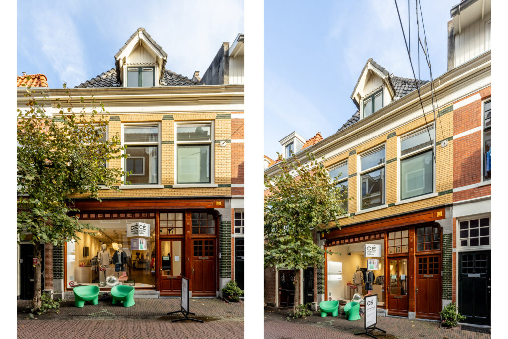 Charming brick storefront with green chairs outside.