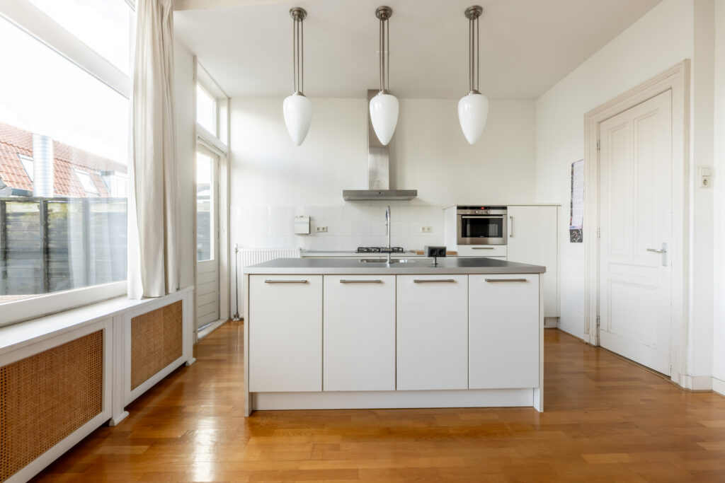 Modern kitchen with island and pendant lights.