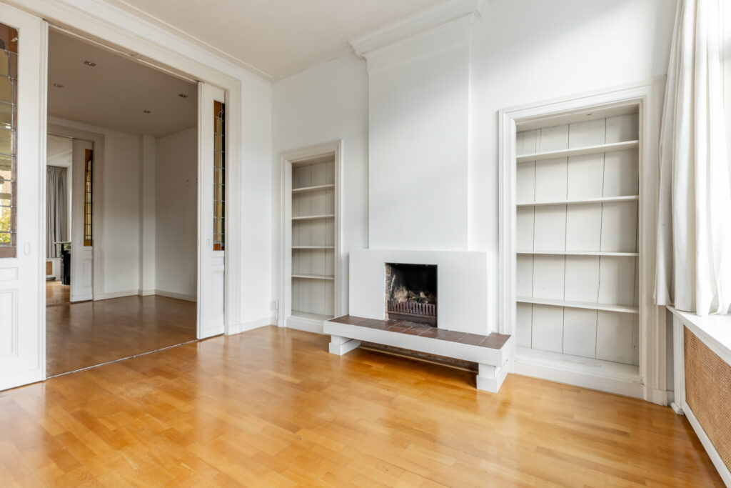 Spacious room with fireplace and built-in bookshelves.