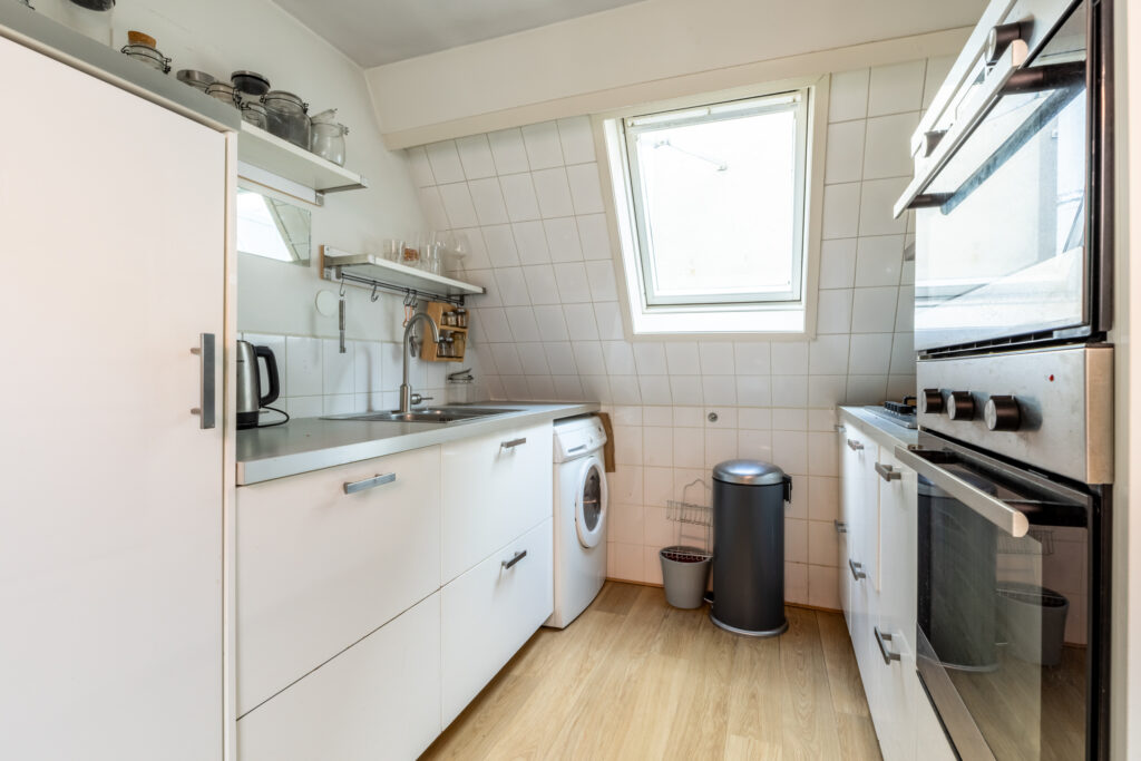 Modern attic kitchen with skylight and appliances