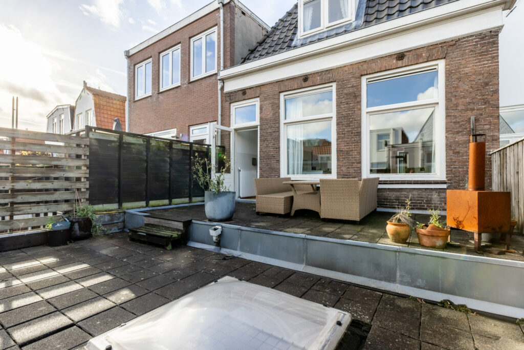 Backyard patio with outdoor seating and plants.