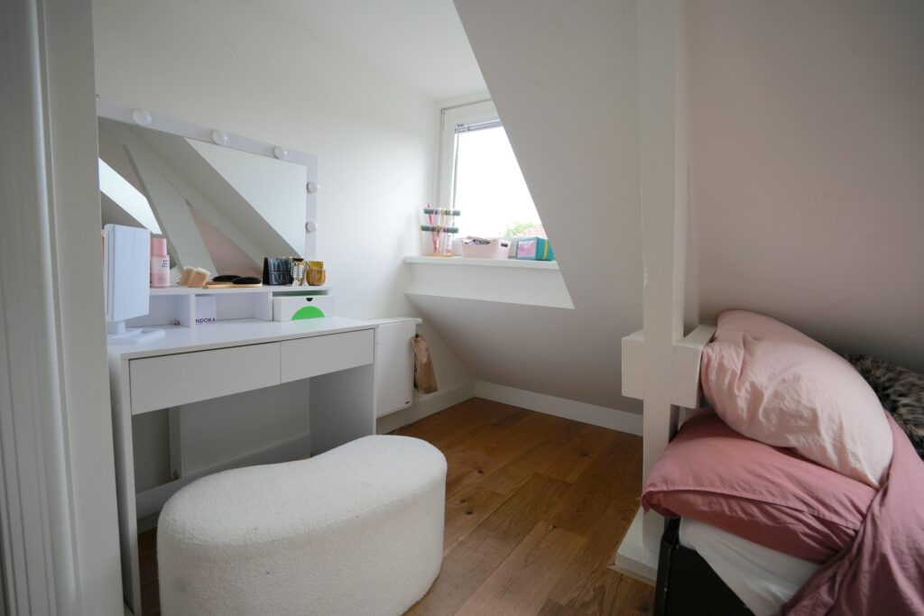 Cozy bedroom with vanity and pink bedding