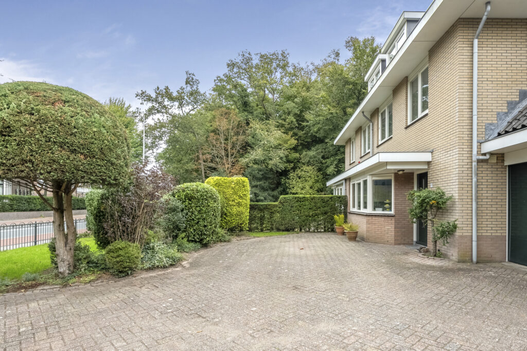 Suburban house with landscaped driveway and trees