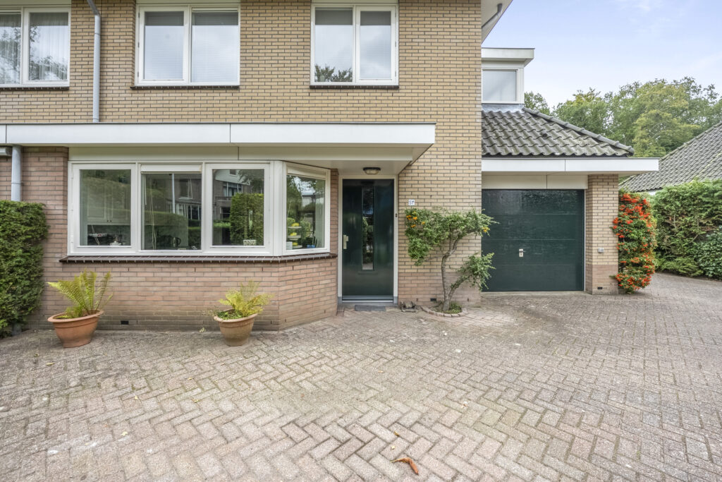 Brick house with green door and driveway