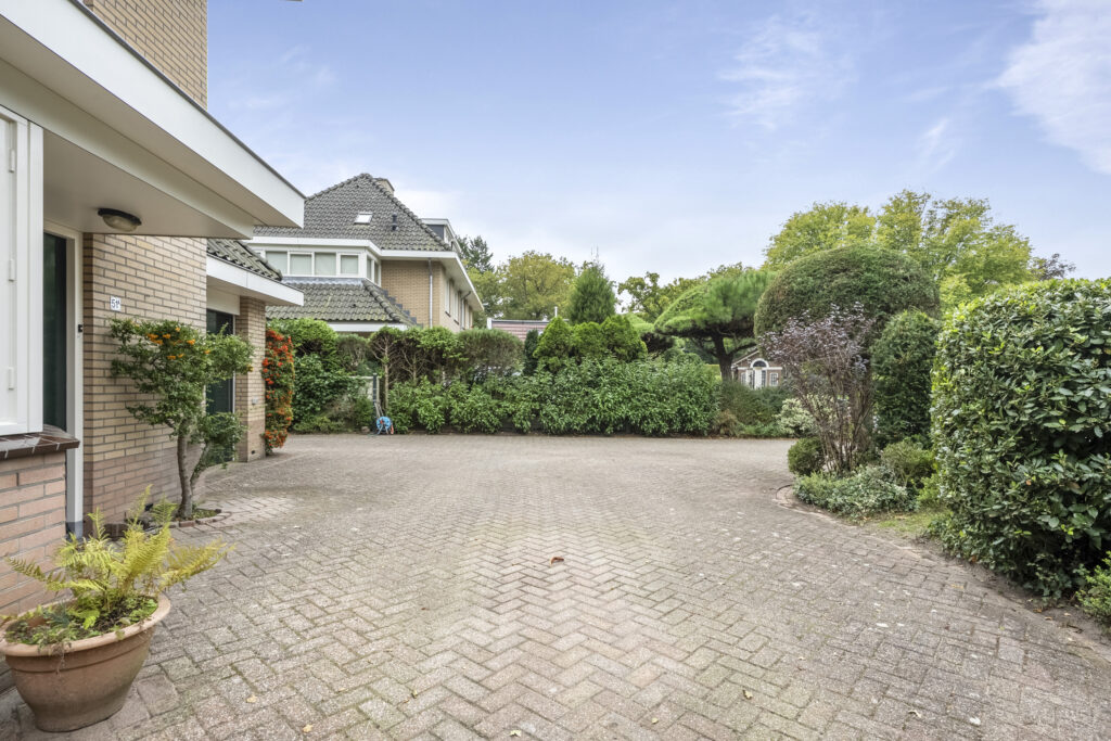 Brick driveway and greenery at residential home