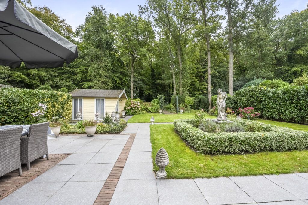 Garden with statue and small wooden shed