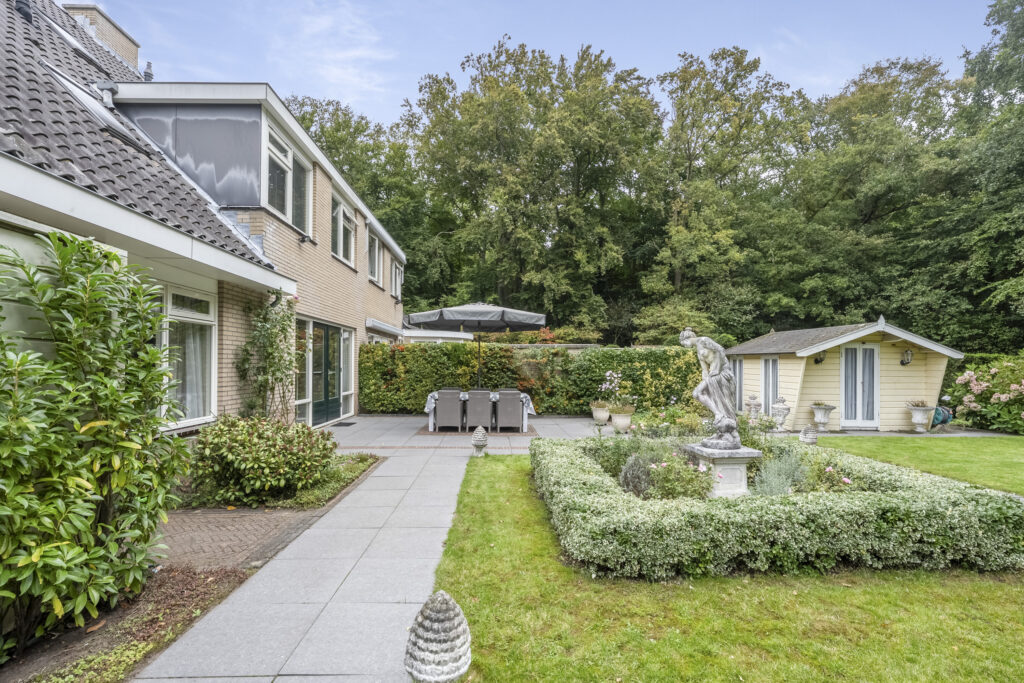 Spacious backyard with patio, garden, and shed.