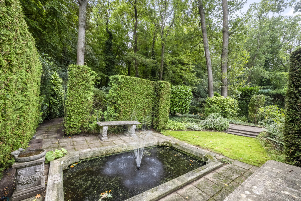 Serene garden with fountain and stone bench