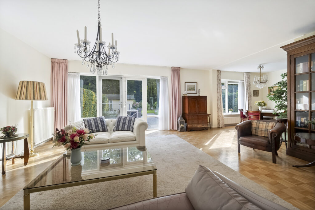 Spacious living room with elegant decor and garden view.