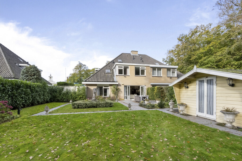 Modern suburban house with garden and patio