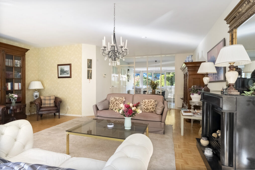 Elegant living room with chandelier and fireplace.