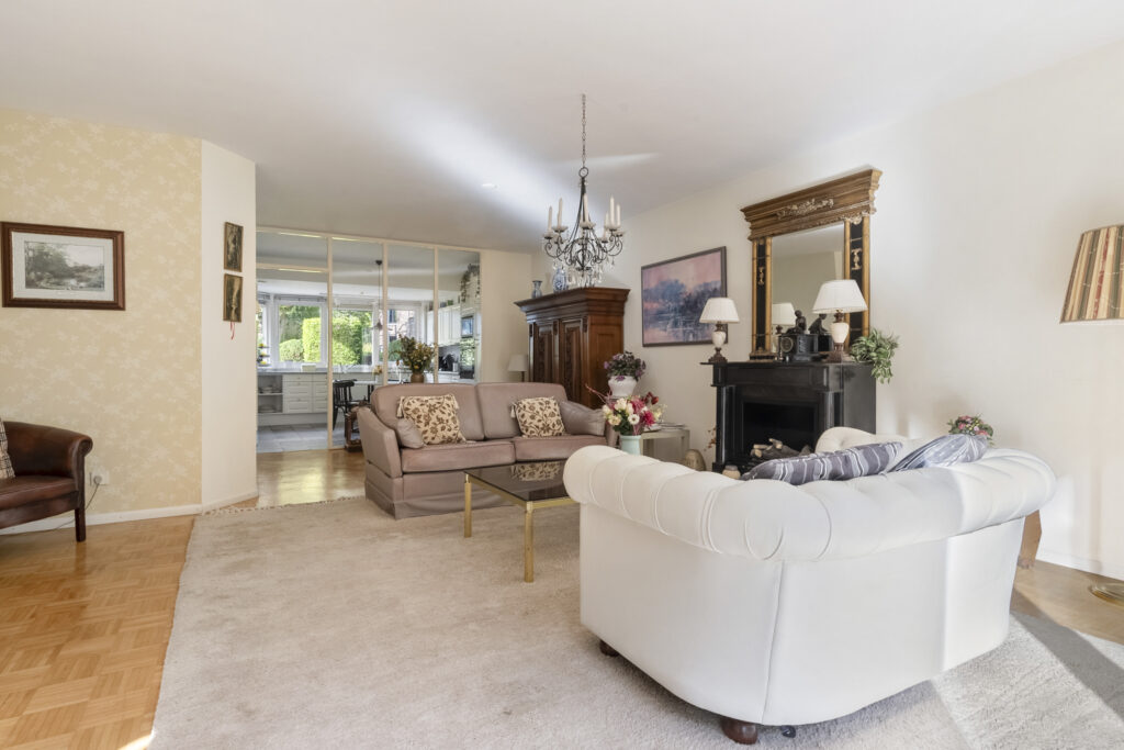Cozy living room with elegant decor and chandelier.