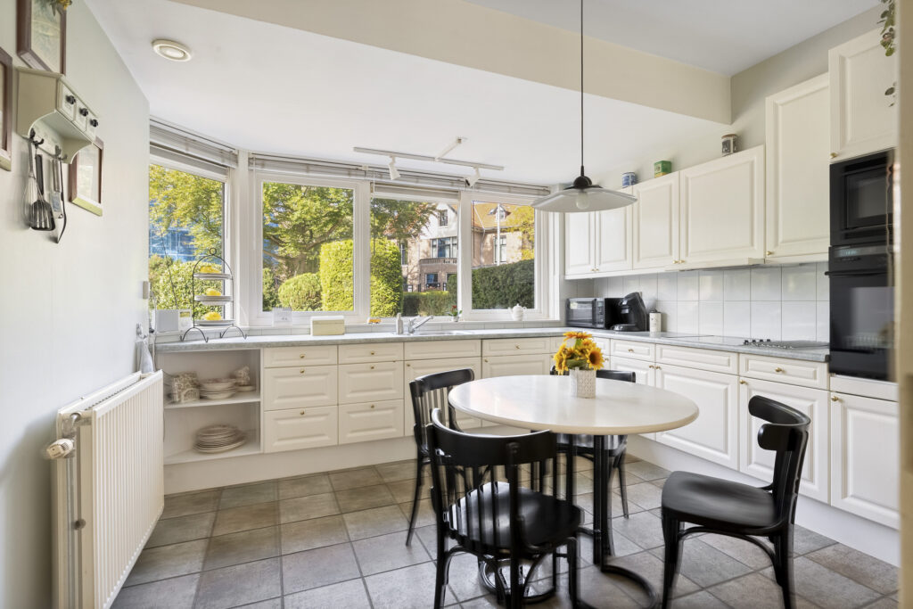 Bright kitchen with modern decor and large windows.