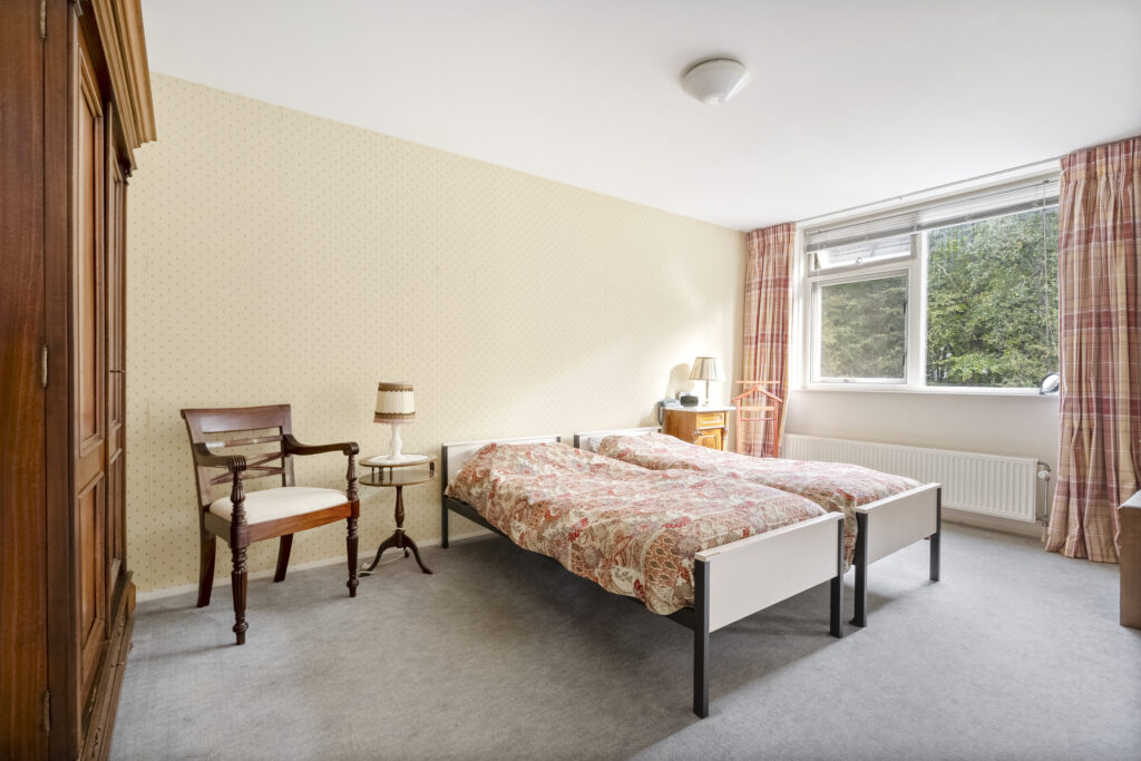 Cozy bedroom with twin beds and vintage decor.