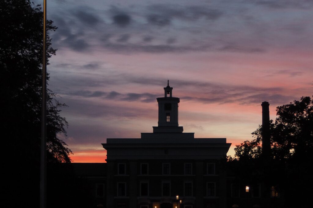 Historic building silhouette against sunset sky