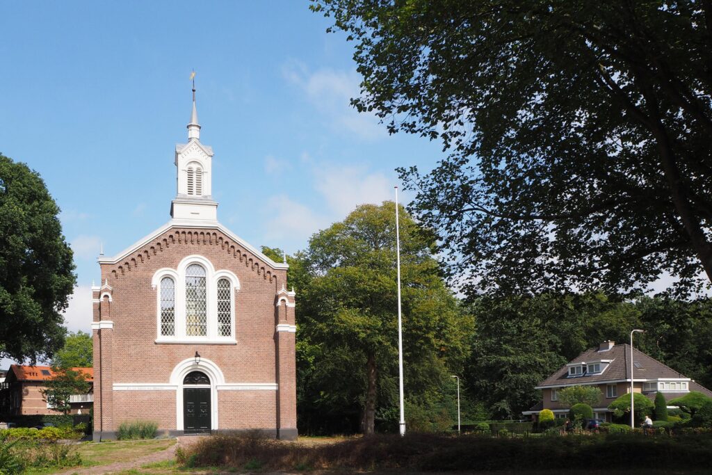 Historic brick church surrounded by trees