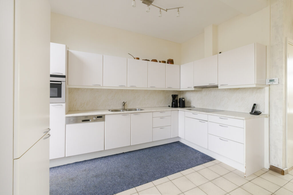 Modern kitchen with white cabinets and appliances