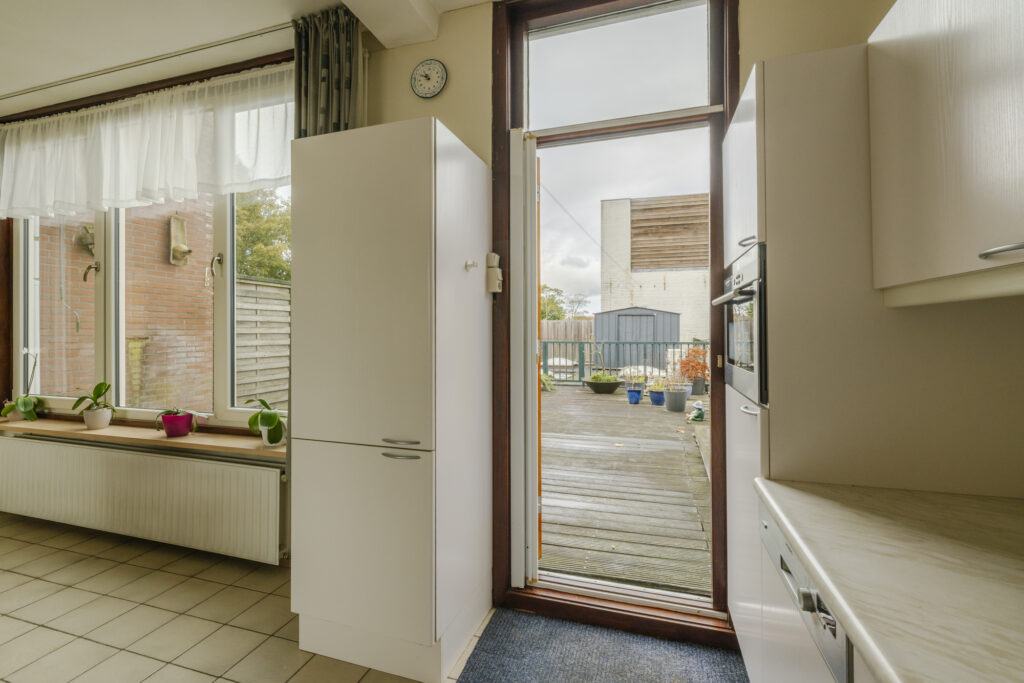 Kitchen with open door to backyard.