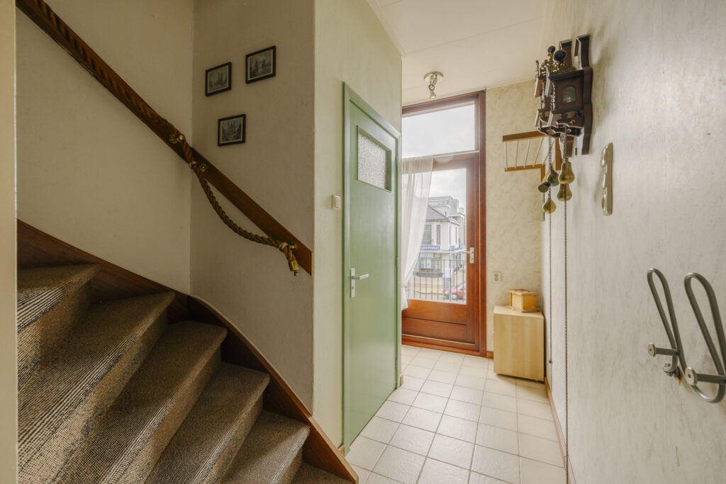House stairway with wall decor and outdoor view.