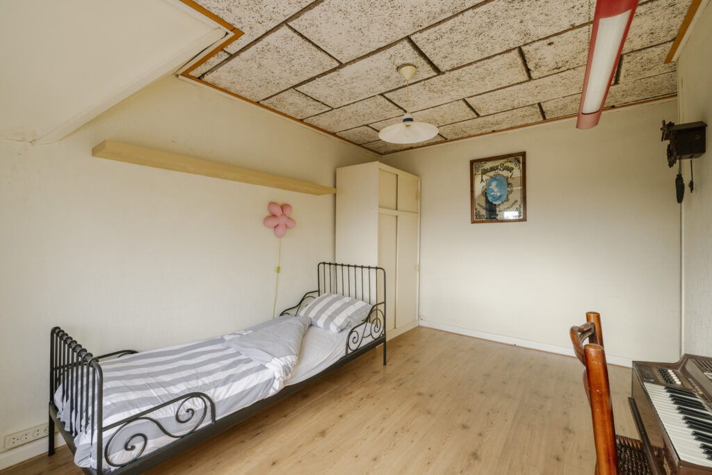 Cozy bedroom with bed and keyboard