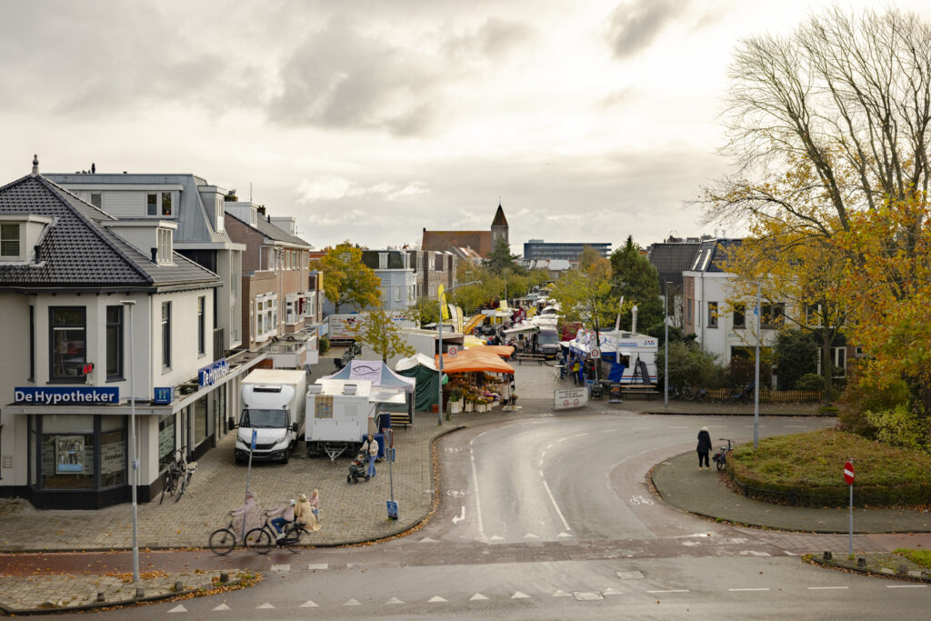 Street view with local market and storefronts.