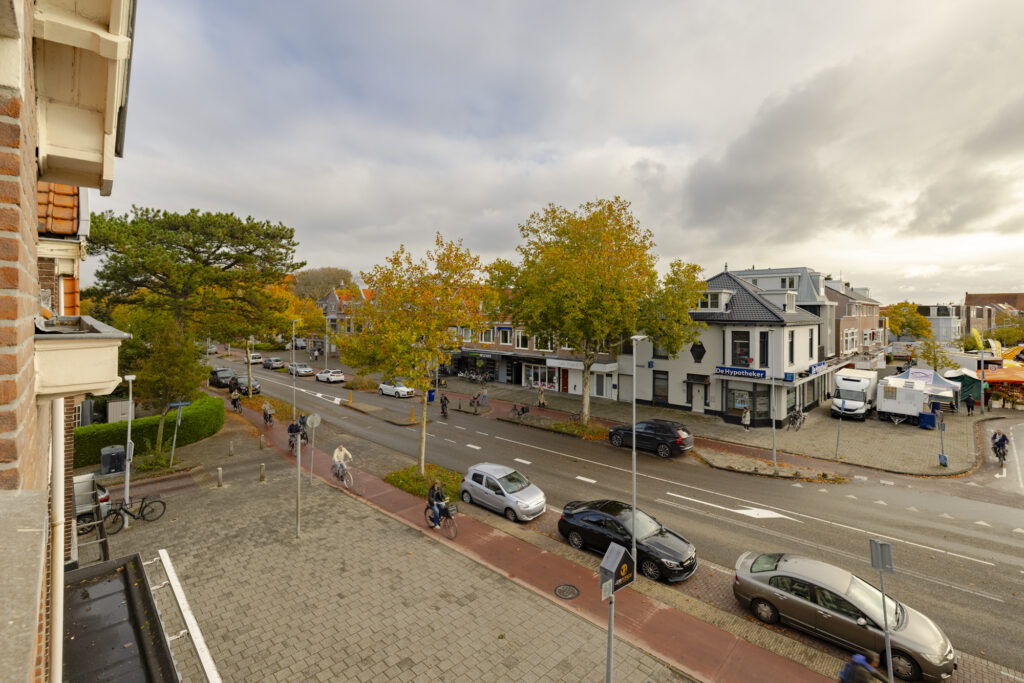Street view with cyclists and parked cars