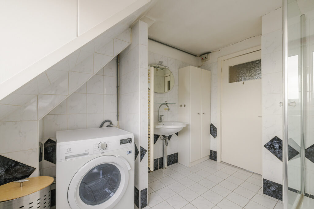 Bathroom with washing machine and sink