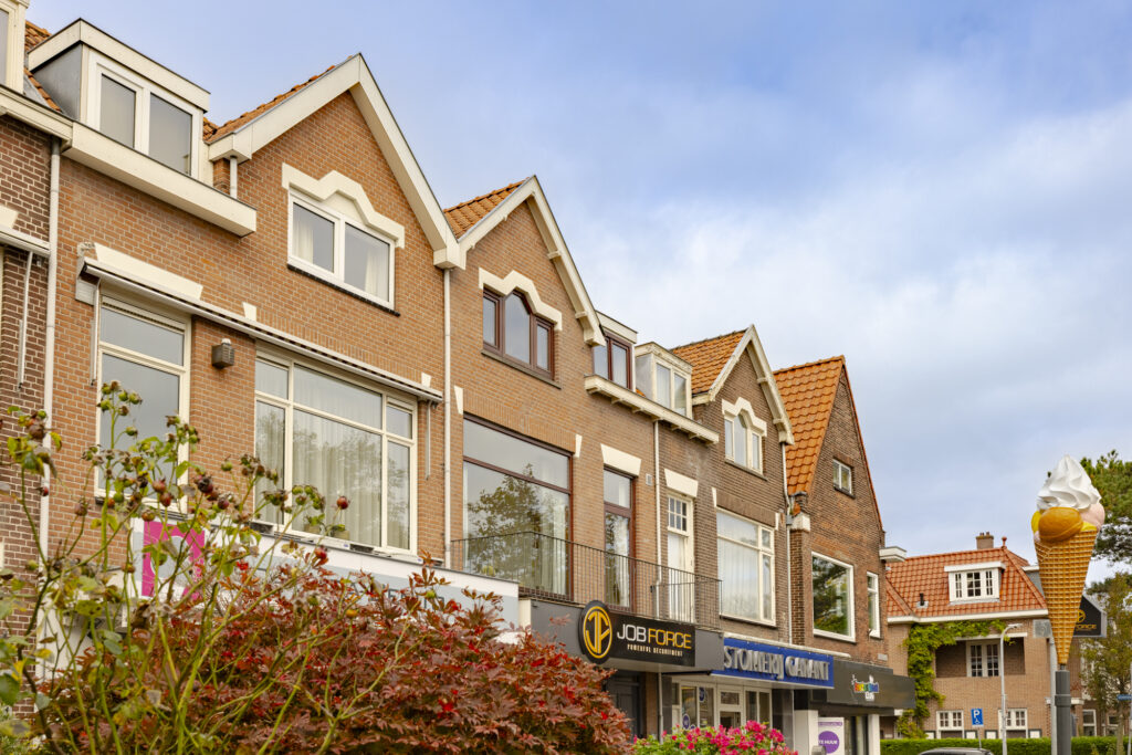 Row of Dutch style buildings, large ice cream cone.