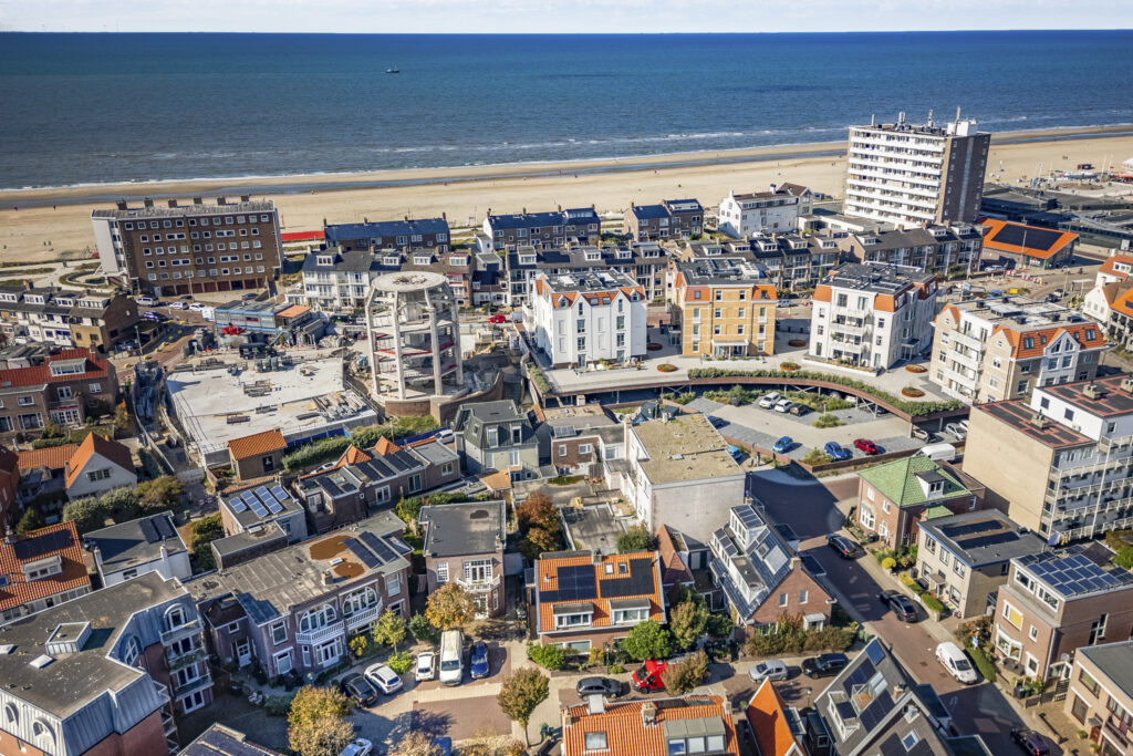 Aerial view of coastal town with beach and ocean.