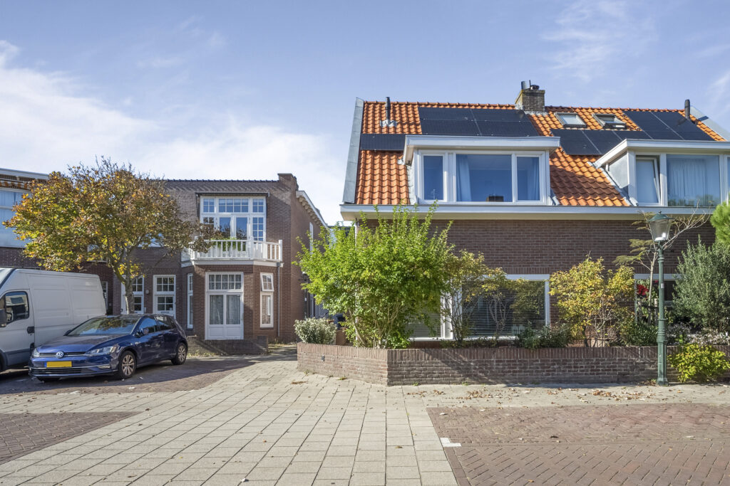 Residential houses with solar panels and parked cars