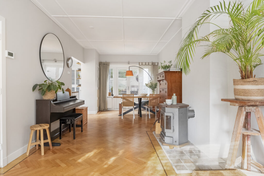 Cozy living room with piano and fireplace.