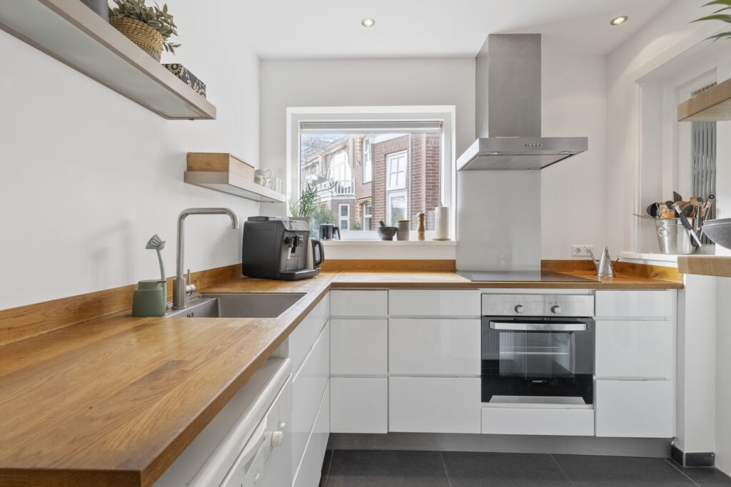 Modern kitchen with wooden countertops and appliances.