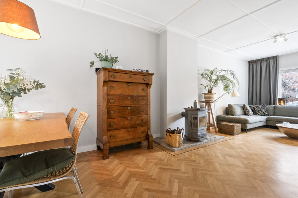 Cozy living room with wooden furniture and fireplace.