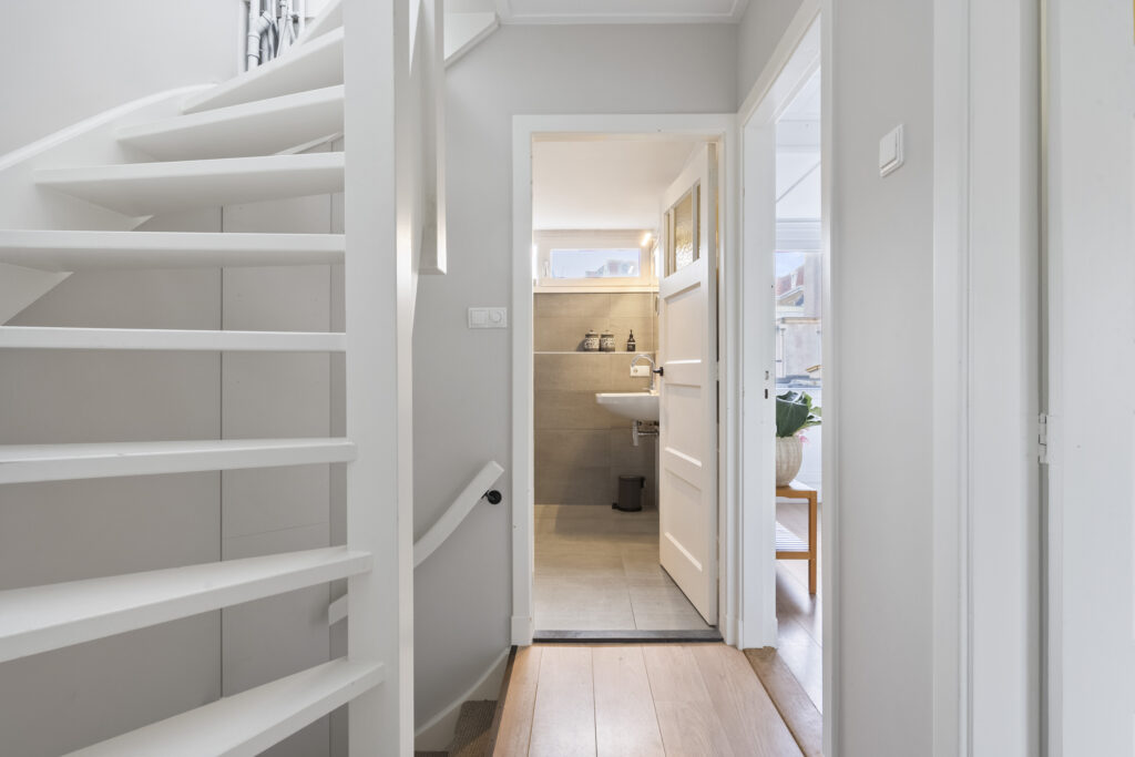 White spiral staircase beside open bathroom door