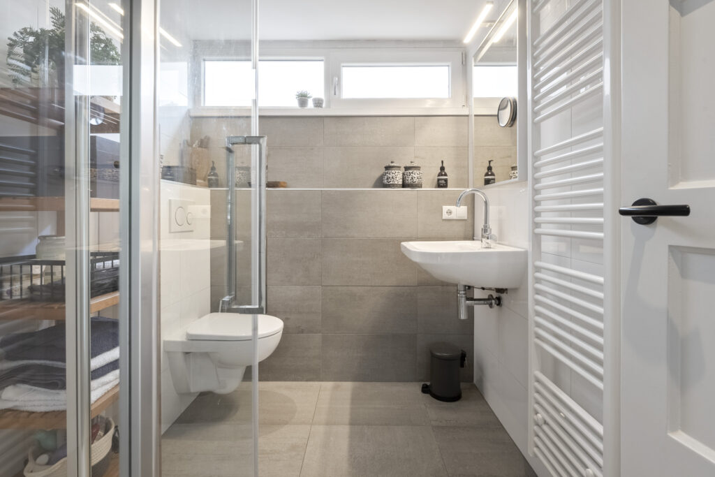 Modern bathroom with sink, toilet, and shower