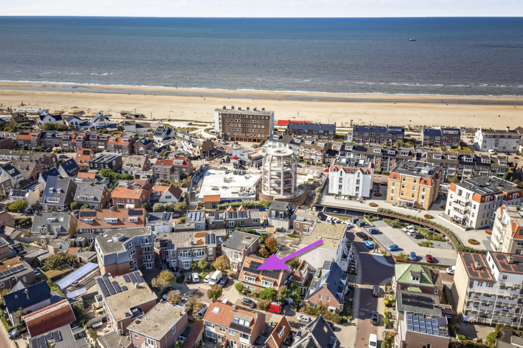 Aerial view of coastal residential area with arrow highlight.