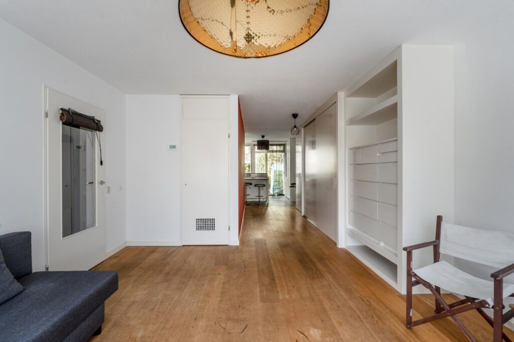 Spacious living room with wooden floor and built-in shelves.