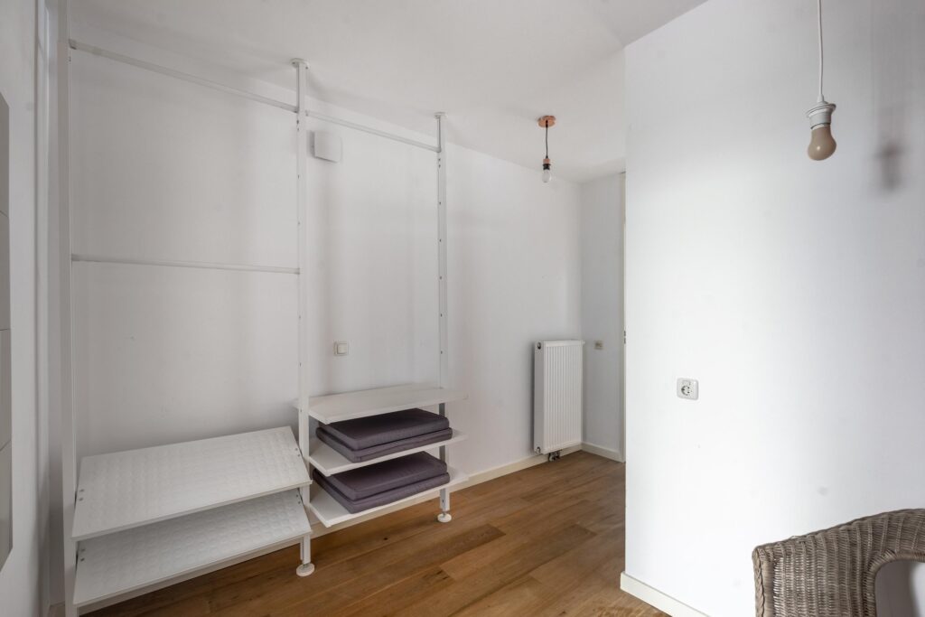 Minimalist room with shelving and wooden floor