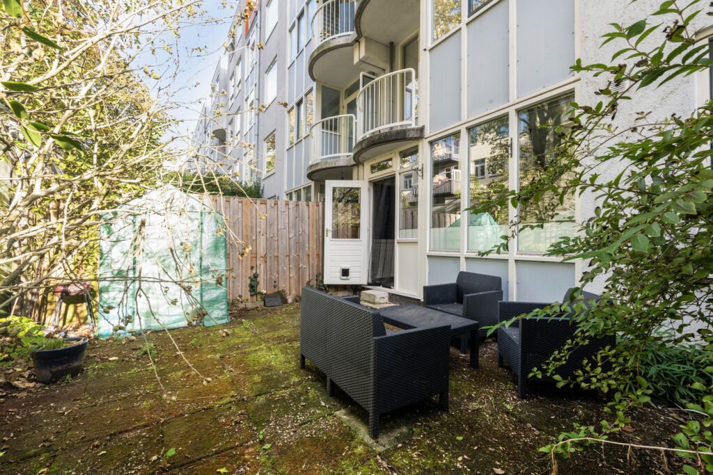 Outdoor patio with furniture and potted plants.