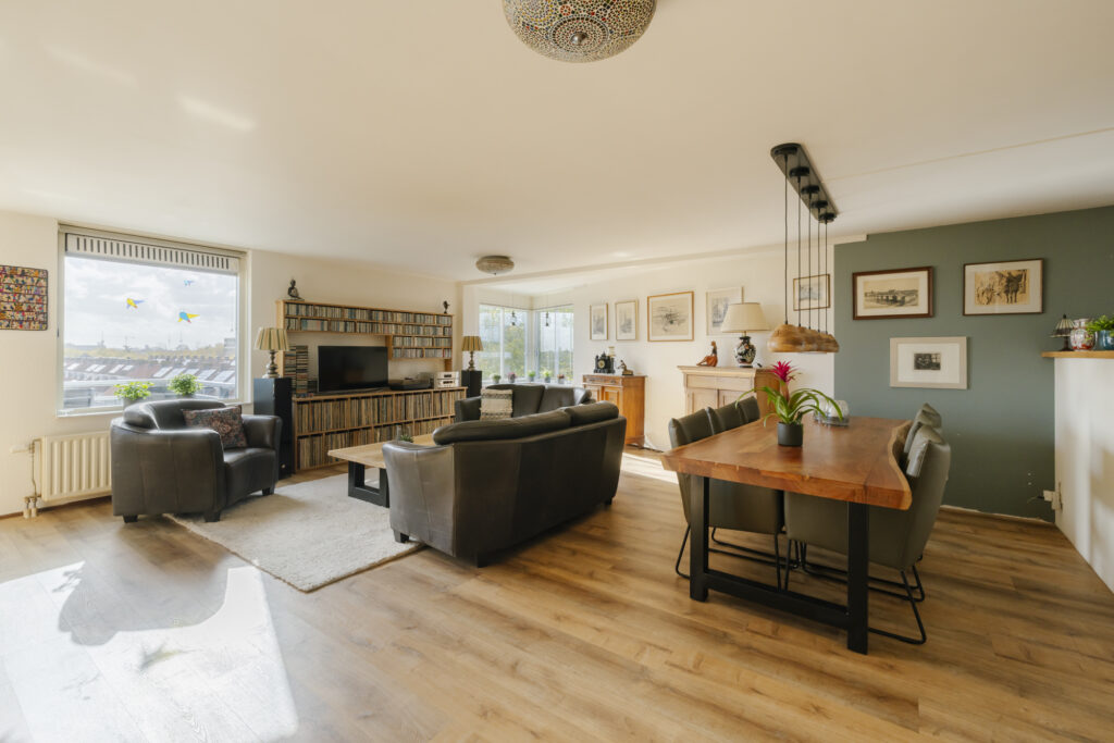 Cozy living room with modern decor and dining table.