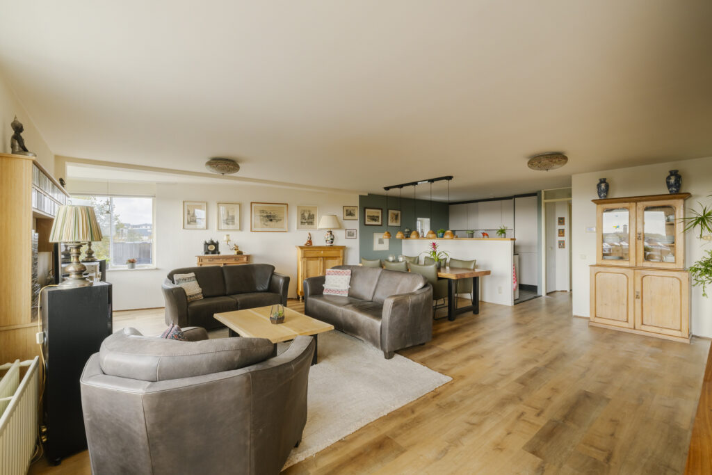 Spacious living room with modern furniture and decor.